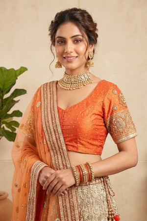 Elegant Orange Silk Blouse with Metallic Champagne Lehenga and Net Dupatta