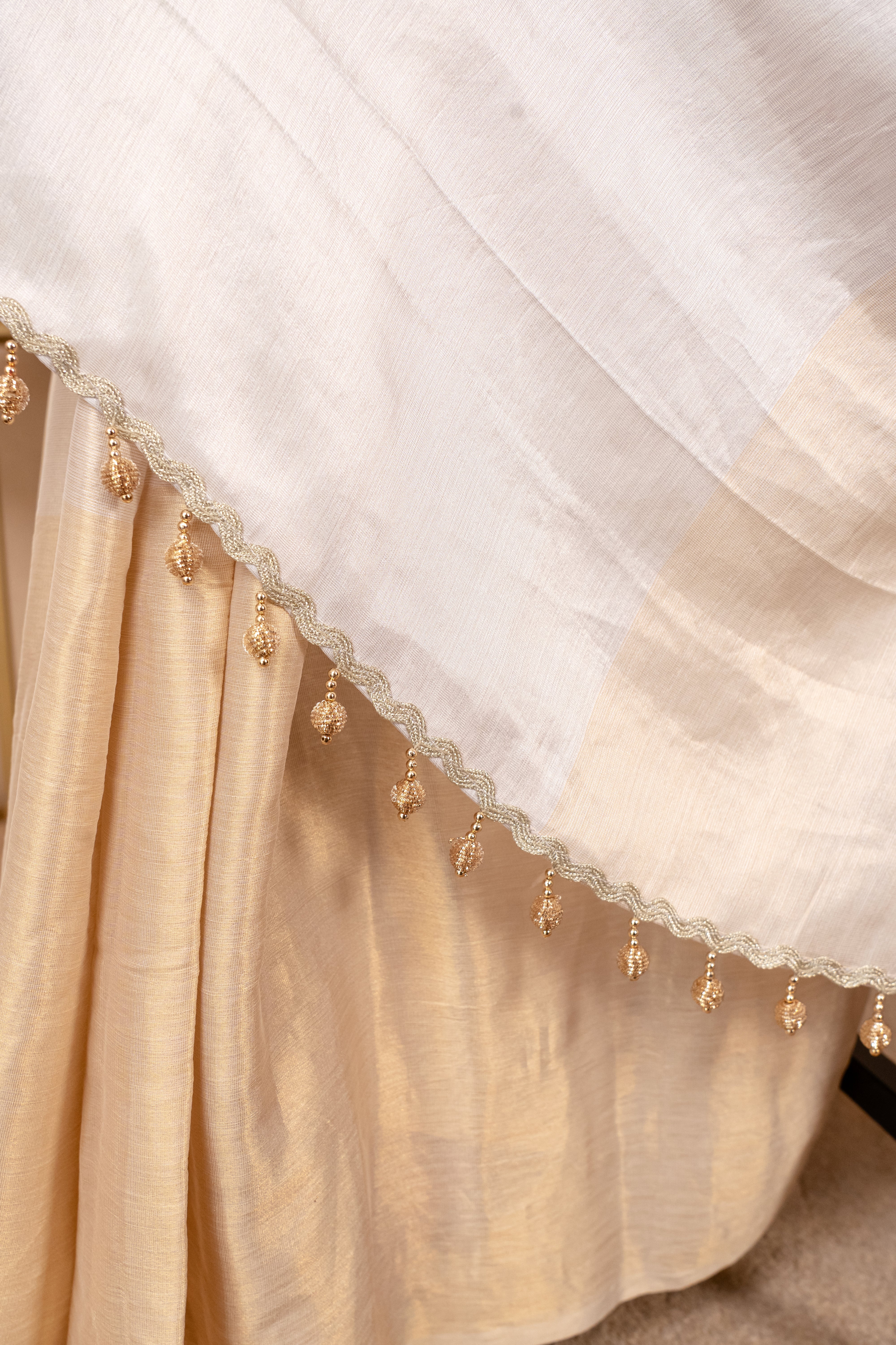 Ethereal White & Gold Soft Tissue Saree with Tassel Detailing