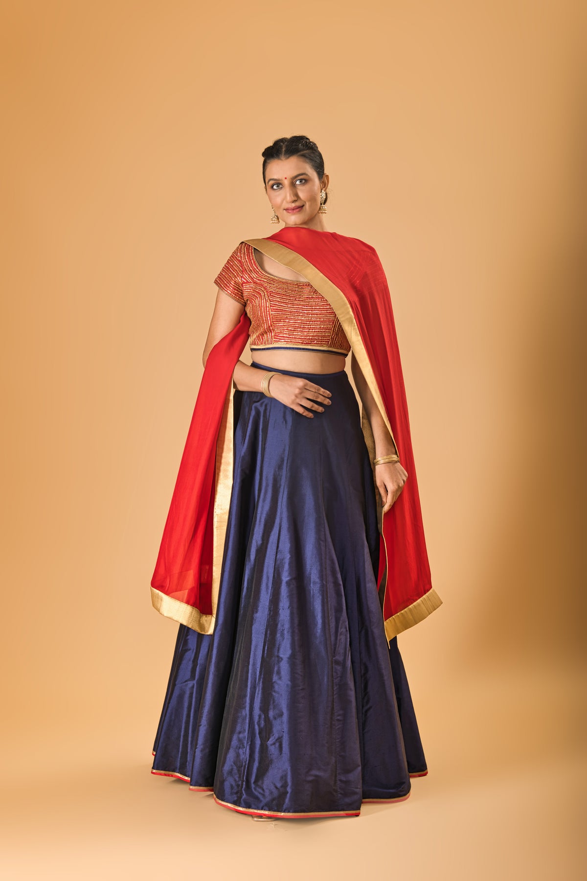 Striking Red Embellished Blouse with Navy Blue Silk Lehenga and Red Dupatta