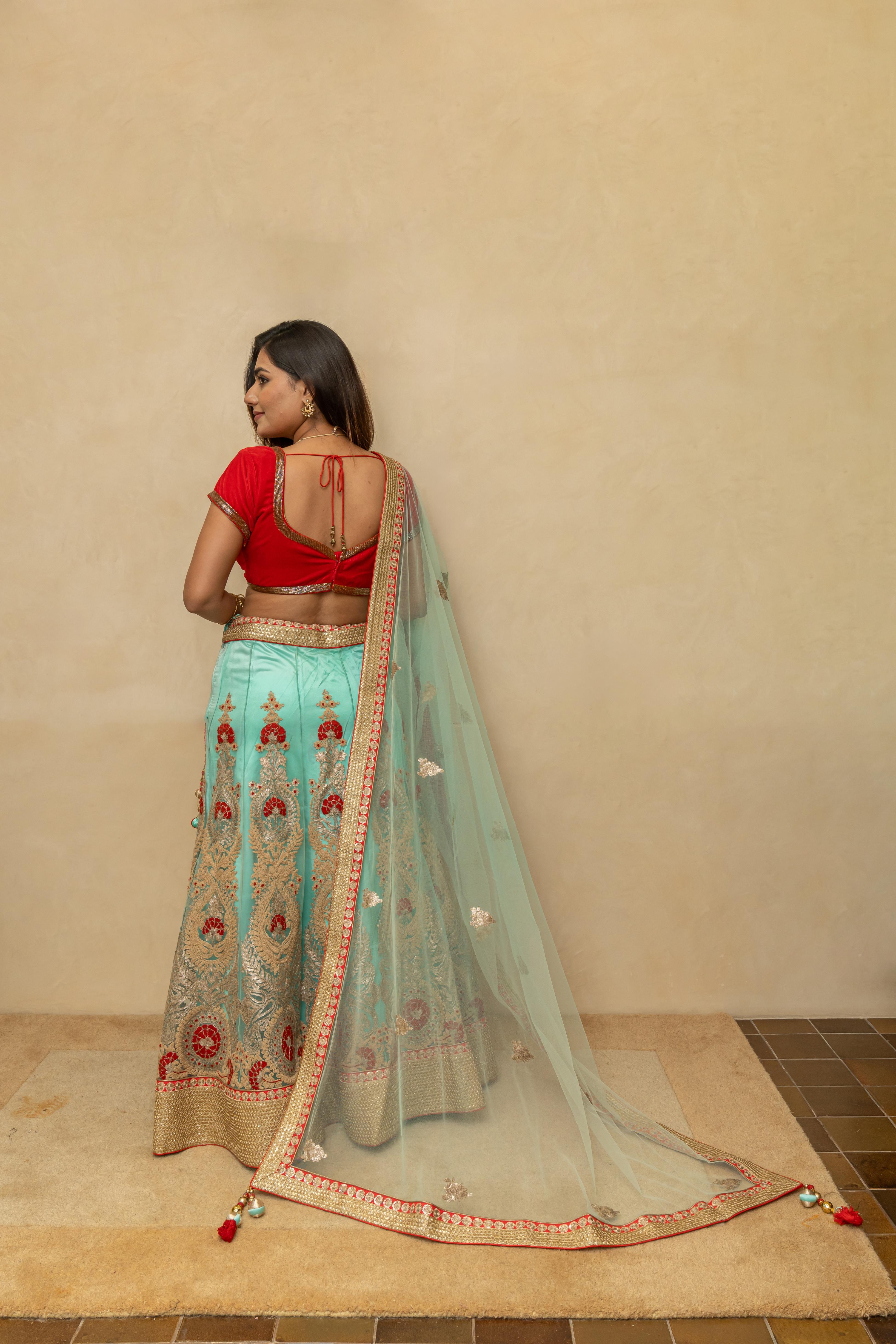 Rich turquoise blue and red threadwork lehenga set