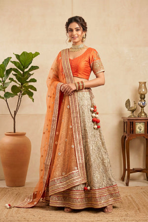 Elegant Orange Silk Blouse with Metallic Champagne Lehenga and Net Dupatta