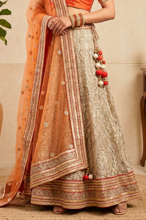 Elegant Orange Silk Blouse with Metallic Champagne Lehenga and Net Dupatta