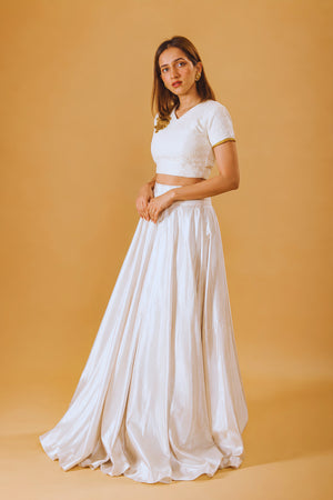 Pristine White Silk Flared Skirt and Embroidered V-Neck Blouse with Gold Accent